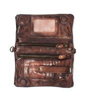The Bed Stu Cadence EM is a brown embossed leather clutch wallet featuring multiple zippered compartments, card slots, a snap button strap, and a transparent ID window—stylish yet practical for everyday use.