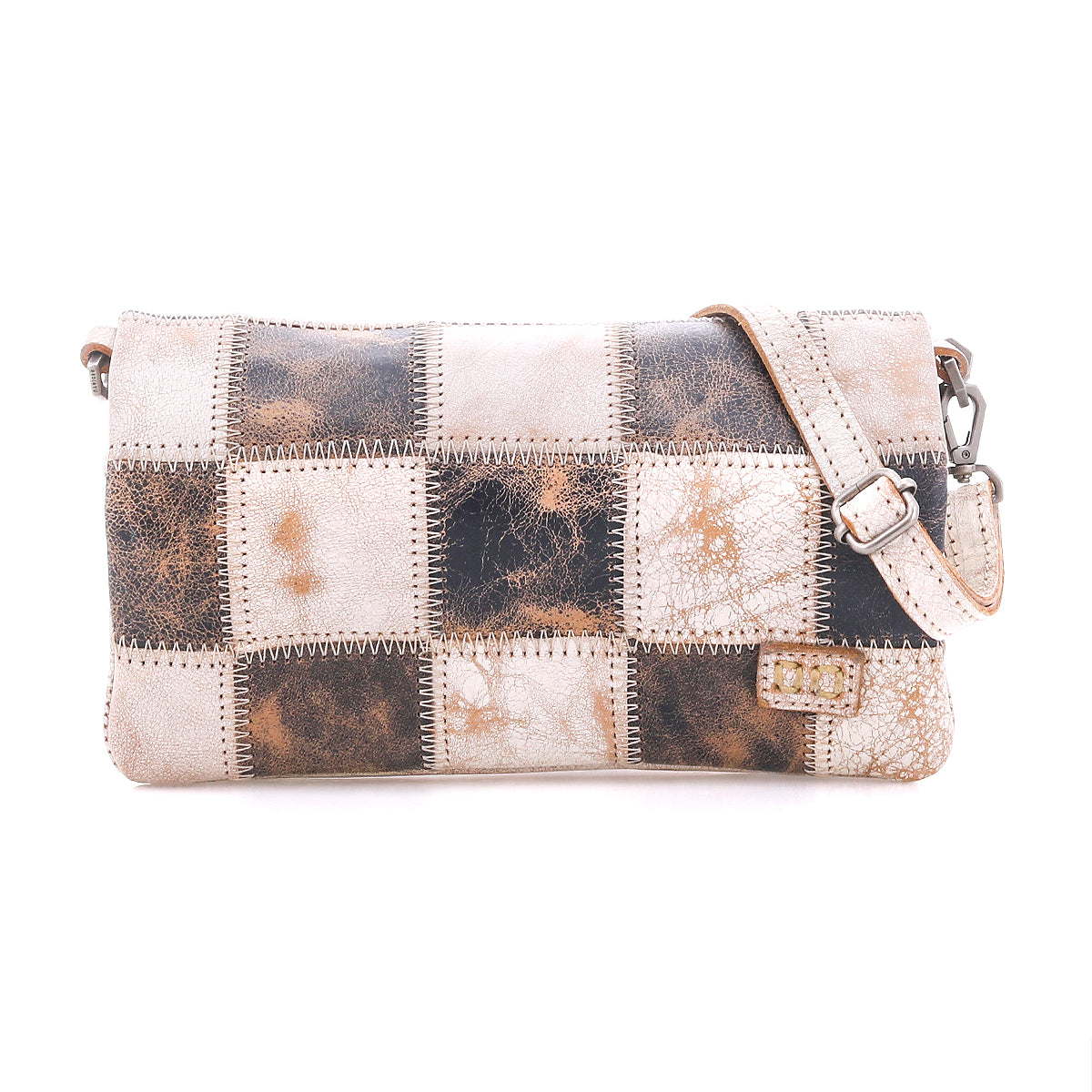 Cadence PW by Bed|Stü is a rectangular shoulder bag crafted from vegetable-tanned leather squares in brown, cream, and tan patchwork. It features a matching adjustable strap and a small tag detail on the lower right.