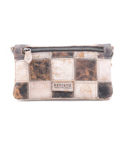 The Cadence PW is a rectangular patchwork leather handbag by Bed|Stü, featuring a zipper closure and a blend of tan, brown, and black vegetable-tanned leather squares, with the “Bed|Stü” label displayed on the front.
