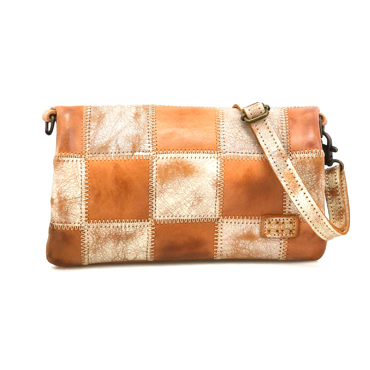 The Bed Stu Cadence PW is a rectangular patchwork leather crossbody bag with an adjustable strap, featuring tan and distressed beige squares on a white background.
