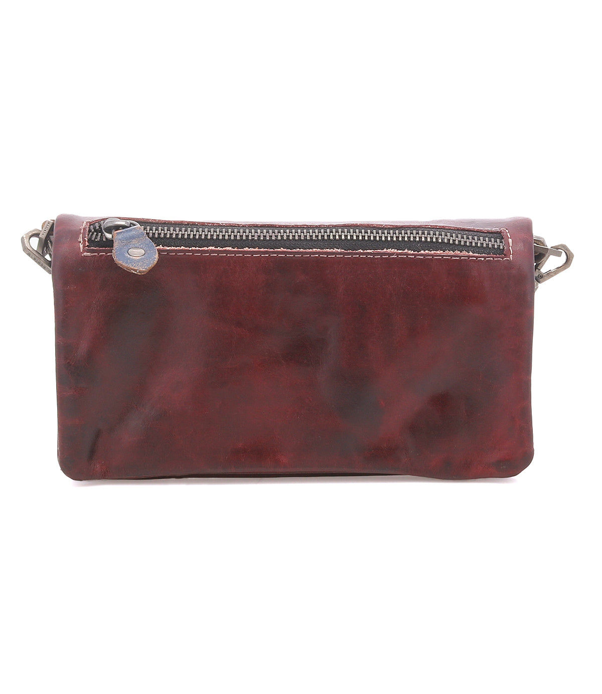 The Cadence by Bed Stu is a rectangular, dark brown crossbody clutch crafted from vegetable-tanned leather, featuring a top zipper and metal clip attachments on both sides.