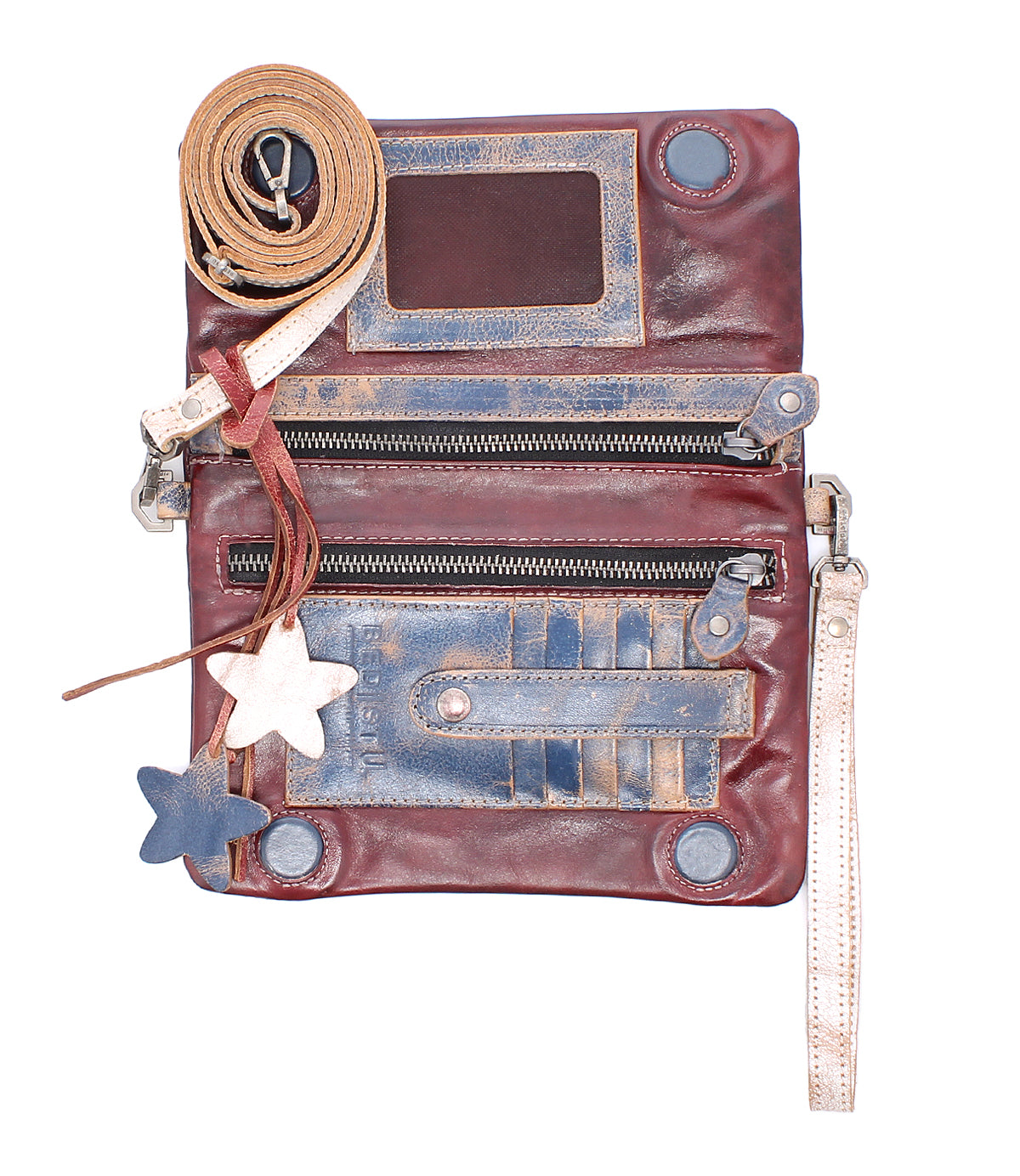 The Bed Stu Cadence is a worn vegetable-tanned leather crossbody clutch featuring zippers, card slots, a clear ID window, detachable strap, and two star-shaped keychains.