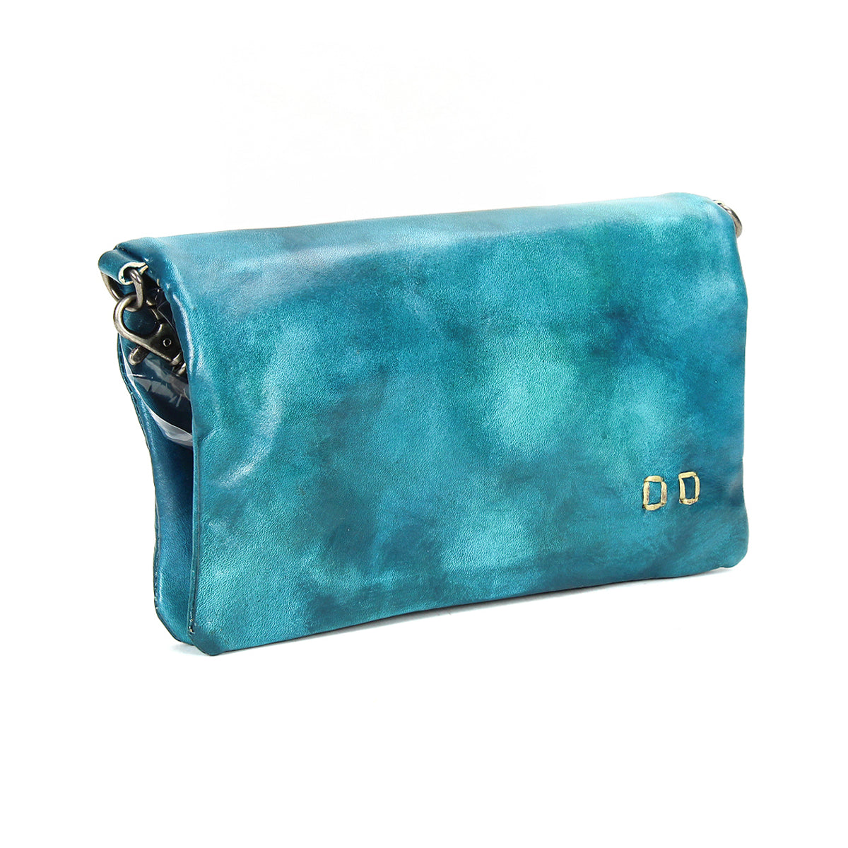 The Cadence by Bed Stu is a turquoise crossbody clutch made from vegetable-tanned leather, featuring a flap closure and two small gold rectangular accents on the front.
