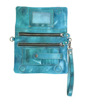 The Cadence by Bed Stu is a turquoise leather wristlet that doubles as a wallet clutch, featuring multiple zippered pockets, card slots, a clear ID window, and a detachable strap. Shown lying flat.