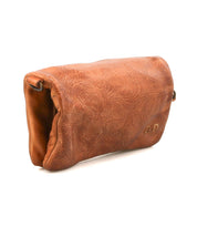 The Bed Stu Cadence EM is a brown leather clutch with a subtle embossed pattern, shown from the side and top flap—an elegant accessory for any occasion.