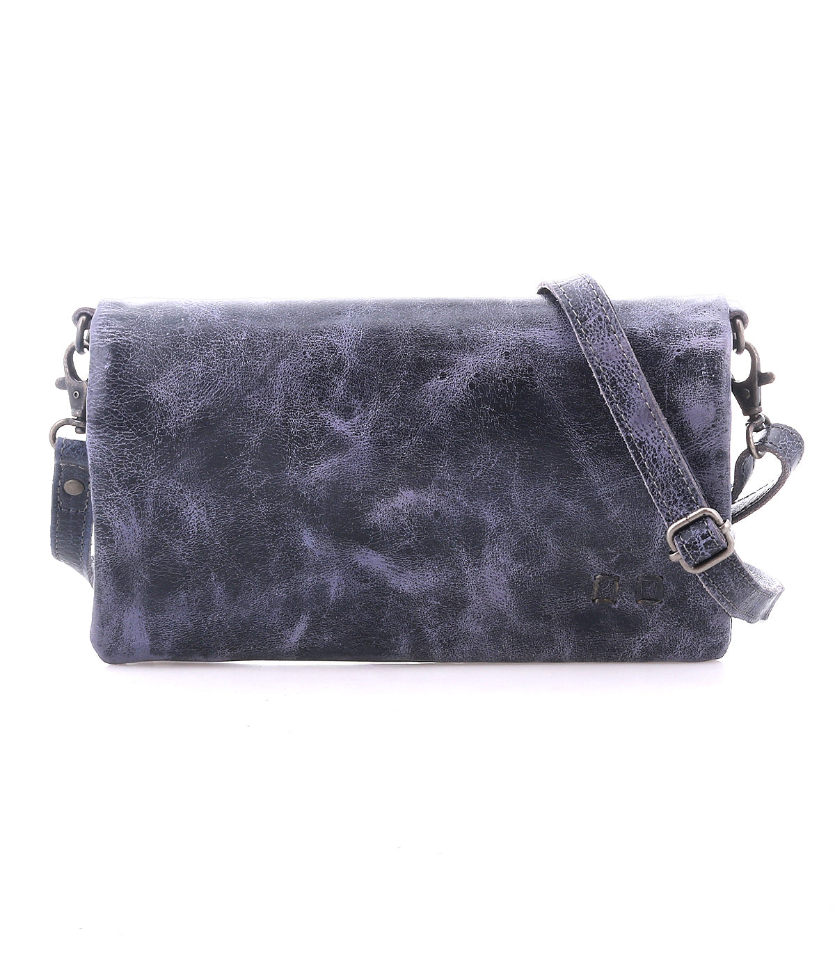 The Bed Stu Cadence is a rectangular dark blue leather crossbody bag with a textured finish and long adjustable strap, versatile enough to be worn as a clutch, shown against a white background.