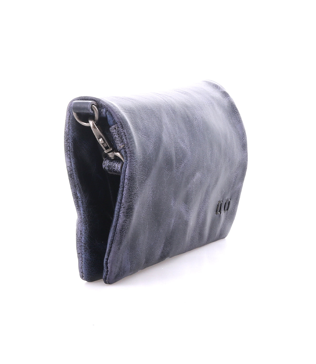 The Cadence by Bed Stu is a small, dark blue leather compact wallet with a partially visible metal clasp, shown against a white background.