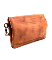 The Bed Stu Cadence is a brown leather clutch with a fold-over flap and side metal clasp, offering a minimalist design—perfect as a compact wallet for your essentials.