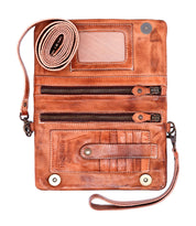 The Bed Stu Cadence is a brown leather compact wallet featuring multiple zip compartments, card slots, an ID window, and a detachable wrist strap—versatile enough to be used as a clutch for any occasion.