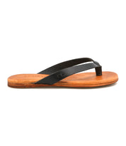 The Bed Stu Calma sandal features comfortable black leather thong straps with a tan sole, shown side view on white background—ideal relaxing footwear for any occasion.