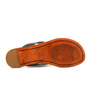 The image shows the sole of the Bed Stu Calma leather sandal, featuring a textured grip area and an engraved Bed Stu logo at the center. The heel is plain, slightly raised, highlighting Calma’s relaxed footwear design.