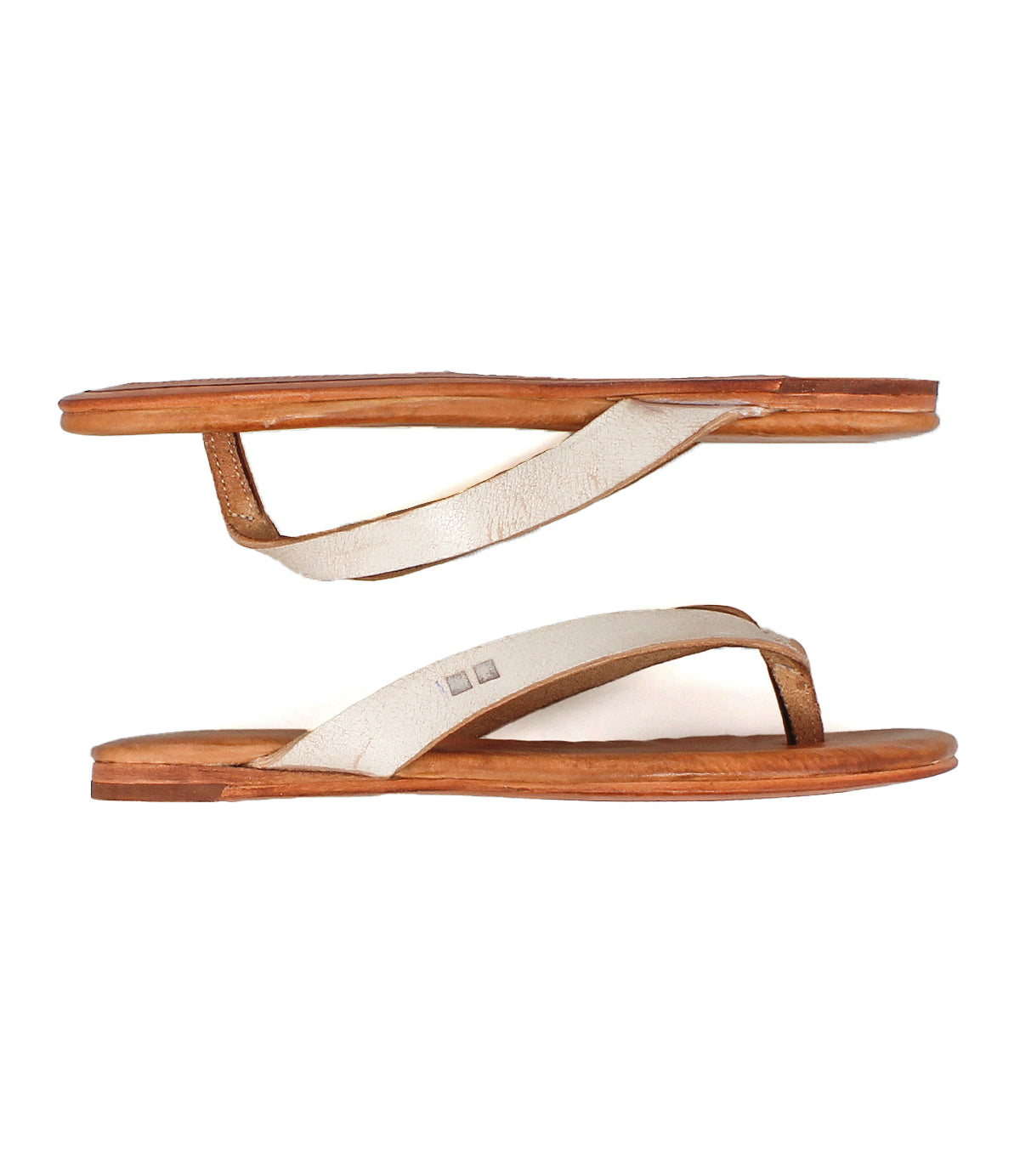 The Bed Stu Calma sandals feature flat tan leather soles and off-white straps, shown in a side view on a white background—a perfect choice for relaxed, versatile style.