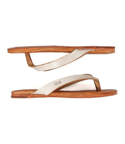The Bed Stu Calma sandals feature flat tan leather soles and off-white straps, shown in a side view on a white background—a perfect choice for relaxed, versatile style.