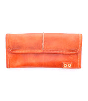 The Bed Stu "Canton" is a closed brown leather wallet with elegant white stitching, displayed against a crisp white background. This stylish design features convenient card slots for organized storage.