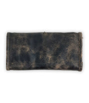 The Canton by Bed Stu is a dark leather pencil case with a rustic, rolled-up appearance, resembling a chic clutch, photographed from above on a plain white background.