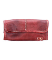 The Bed Stu Canton is a rectangular brown-red leather wallet featuring white stitching, multiple card slots, and a small decorative patch in the bottom right corner.