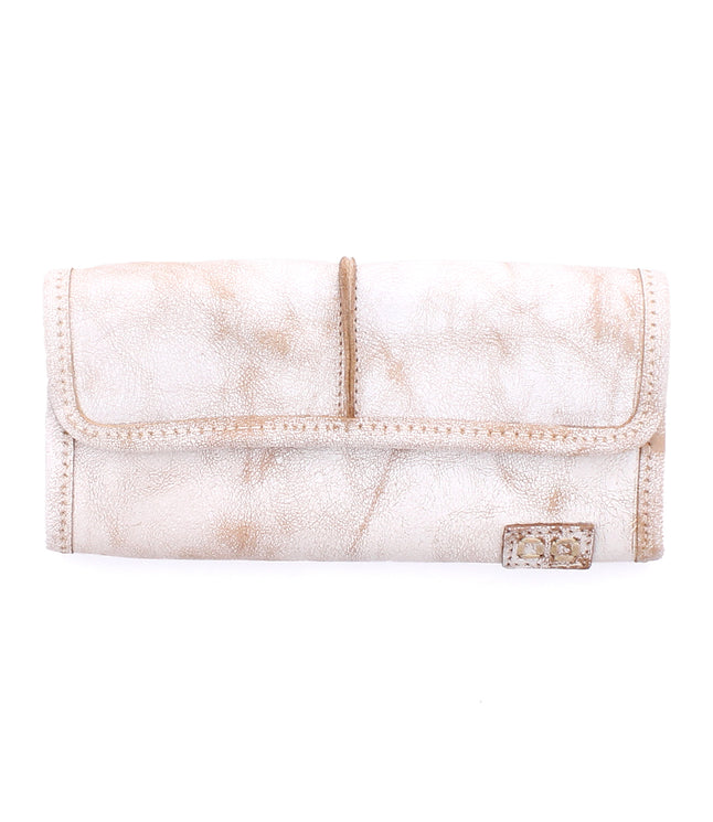 The white leather Canton wallet by Bed Stu features a textured finish, convenient card slots, and a small metal logo plaque on the bottom right corner.