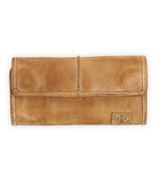 The Canton by Bed Stu is a sleek brown leather wallet featuring card slots, a fold-over flap, and meticulous stitched details.