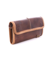 The Bed Stu Canton is a brown leather wallet with tan trim, a stitched flap closure, and a small metal emblem on the lower right. This 2-in-1 design easily doubles as a stylish clutch for versatile use.