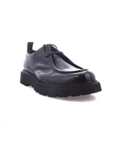 Introducing the "Casotto" by Bed Stu: A black leather shoe exuding retro charm, boasting a thick sole and classic front laces, showcased elegantly against a white background.