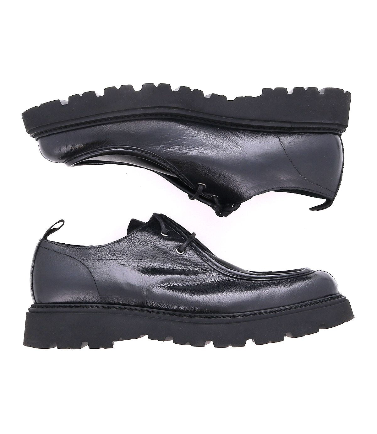 The Casotto boots by Bed Stu are black leather men's lace-up boots with thick soles, displayed from the side and facing opposite directions on a white background. Their Italian craftsmanship and retro flair make them a standout choice.