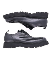The Casotto boots by Bed Stu are black leather men's lace-up boots with thick soles, displayed from the side and facing opposite directions on a white background. Their Italian craftsmanship and retro flair make them a standout choice.