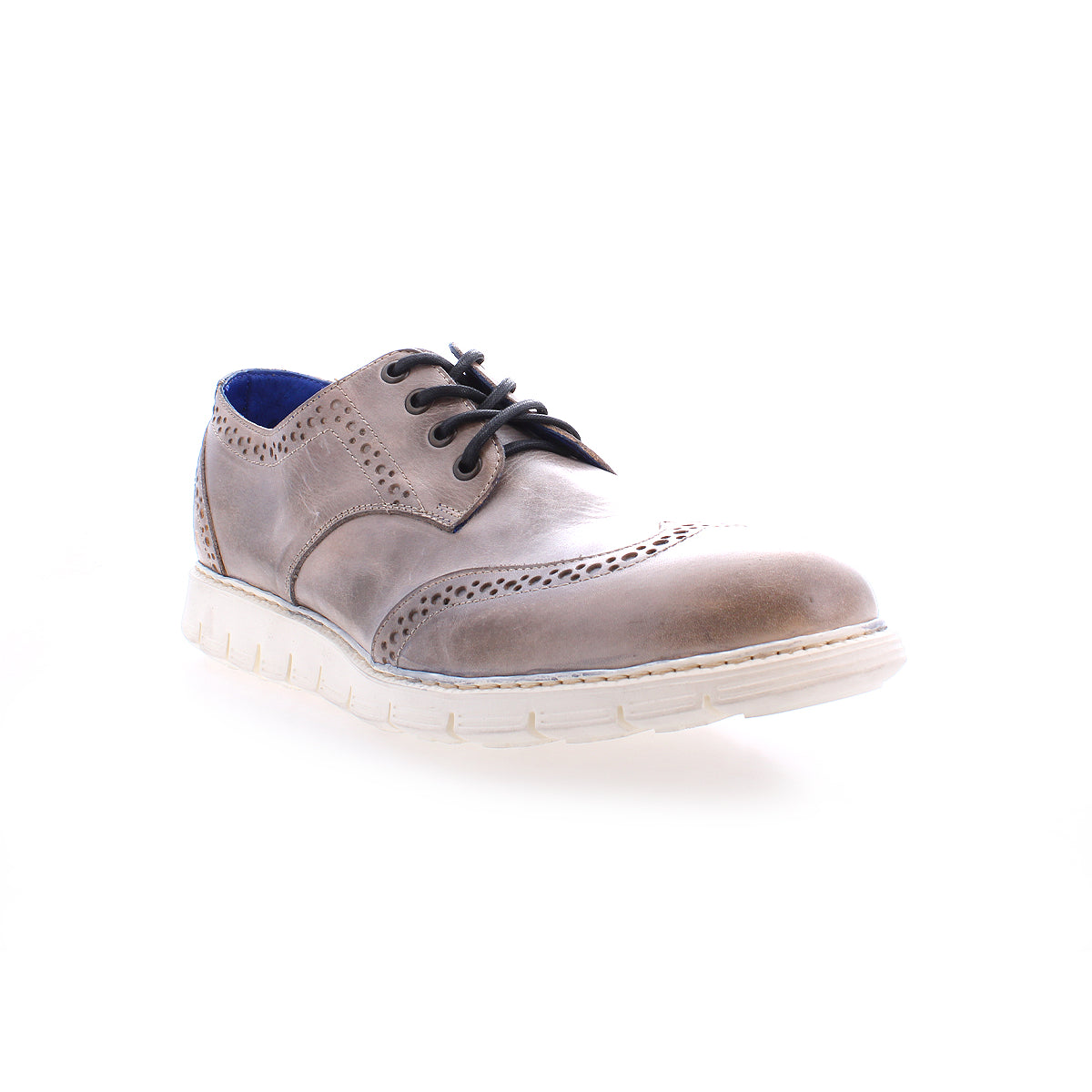 The Cayuga II by Bed Stu is displayed against a white background, featuring a single brown leather dress shoe with black laces and a white sole. This lightweight leather wingtip design, showcasing brogue details, perfectly complements a casual male ensemble.