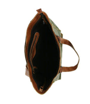 A top-down view of the Bed Stu Celindra LTC, a spacious zip-top tote with brown leather handles and trim, featuring a roomy black interior and an inner zip pocket.