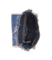 Top view of the Ceremonious by Bed Stu, a preppy blue leather flap-top bag with magnetic closure, zipper compartment, main storage area, and visible interior lining with pockets.
