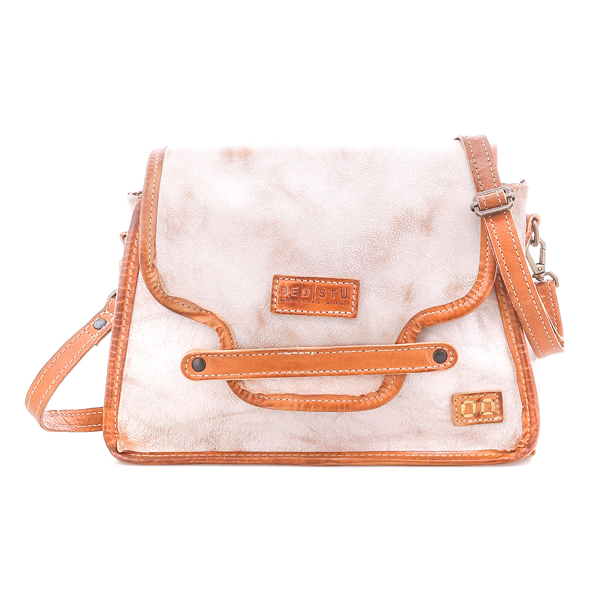 The Bed Stu Ceremonious is a beige and brown preppy bag featuring a front flap, adjustable strap, and visible stitching. Displayed on a white background, this handbag keeps essentials organized in style.