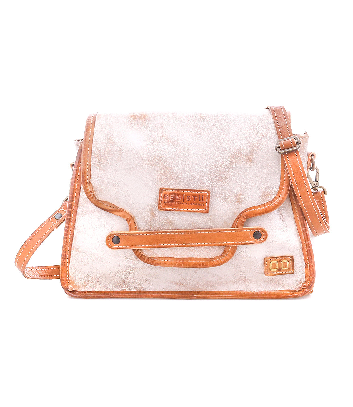 The Bed Stu Ceremonious is a beige and brown preppy bag featuring a front flap, adjustable strap, and visible stitching. Displayed on a white background, this handbag keeps essentials organized in style.