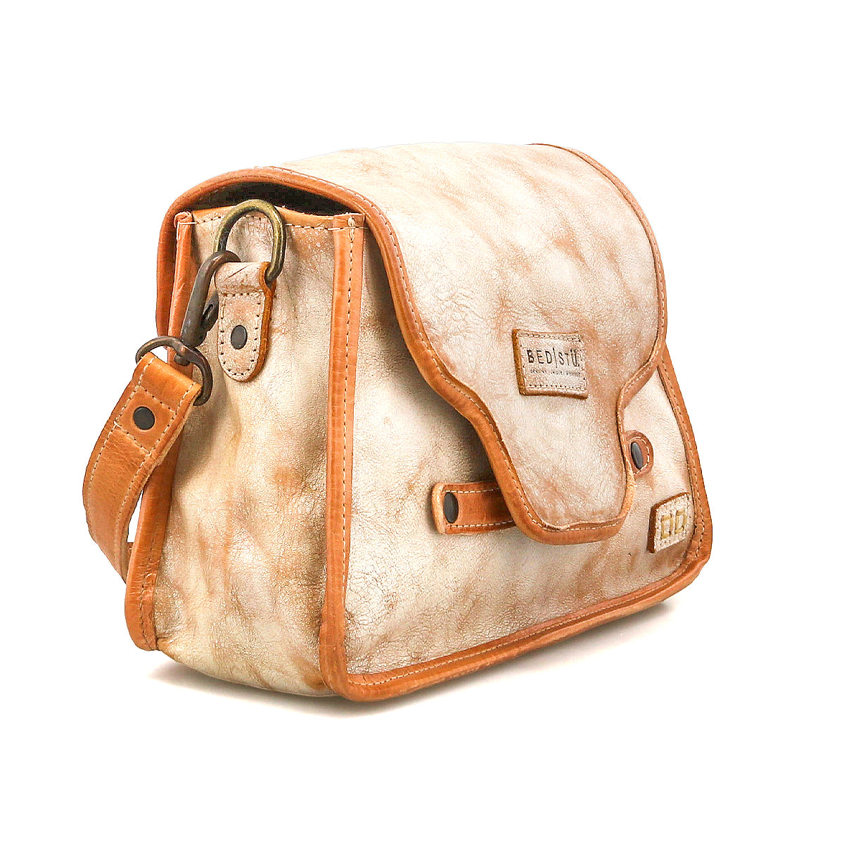 The Ceremonious by Bed Stu is a small tan and brown preppy bag featuring a flap closure, visible stitching, and an adjustable shoulder strap—ideal for everyday style.