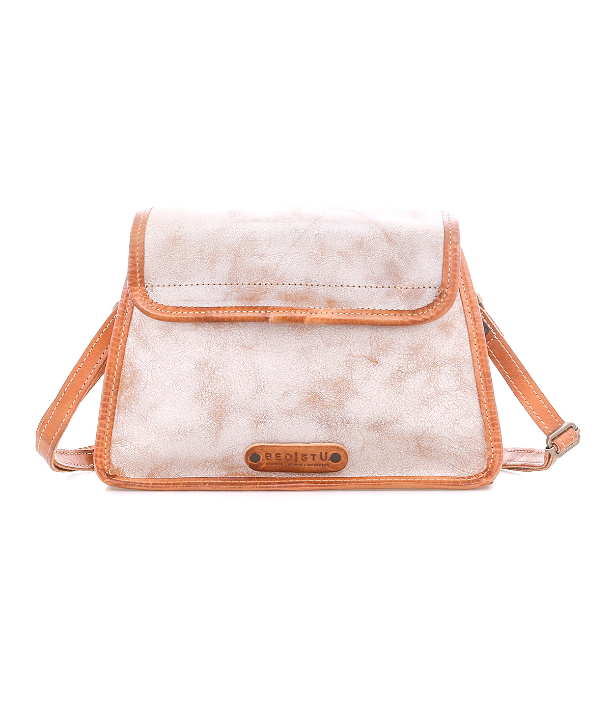 The Bed Stu Ceremonious bag is a light brown flap-top style with a textured flap, contrast stitching, and adjustable strap, shown on a white background for a chic, preppy vibe.