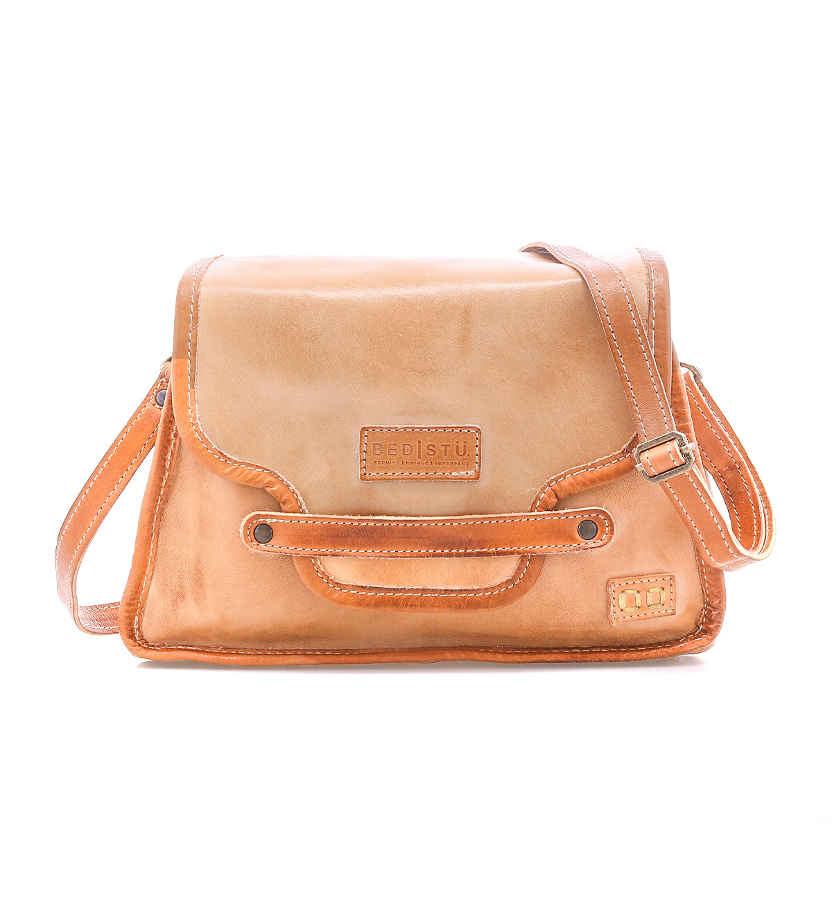 The Ceremonious by Bed Stu is a light brown leather flap-top bag with an adjustable shoulder strap and front logo—a perfect preppy accessory to keep you organized in style.