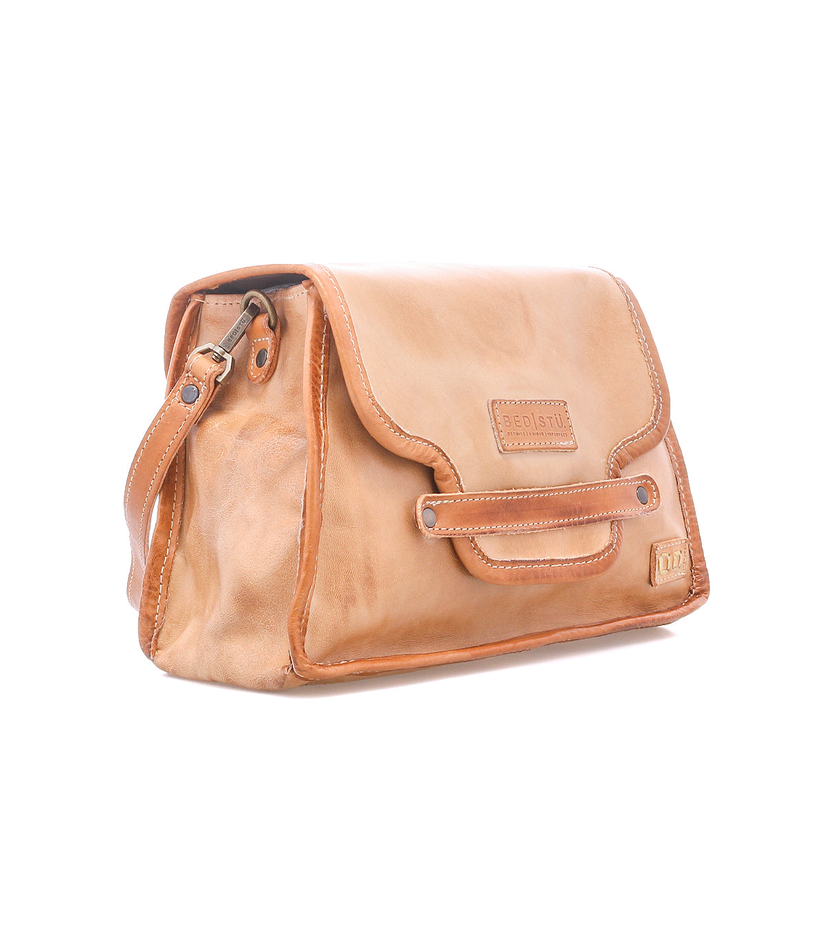The Ceremonious by Bed Stu is a light brown leather flap-top bag with visible stitching, a small front handle, and a stylish preppy vibe—an organized handbag perfect for everyday essentials.