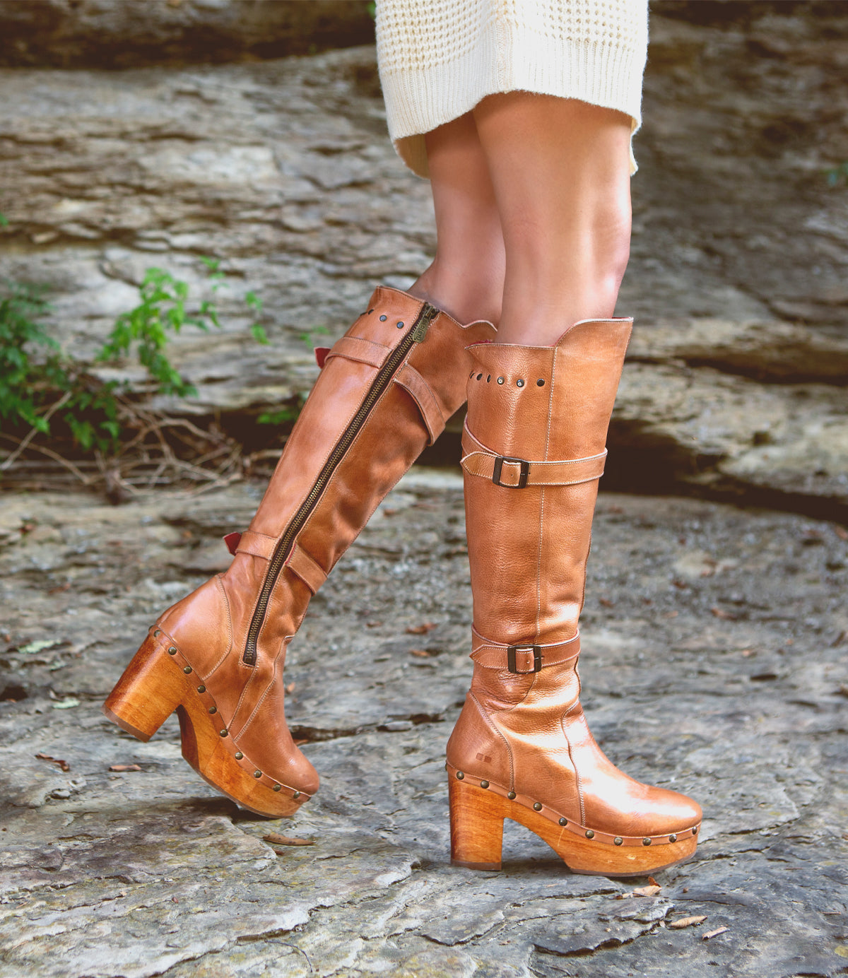 A woman wearing limited-edition Bed Stu Ceretti boots on a rock.