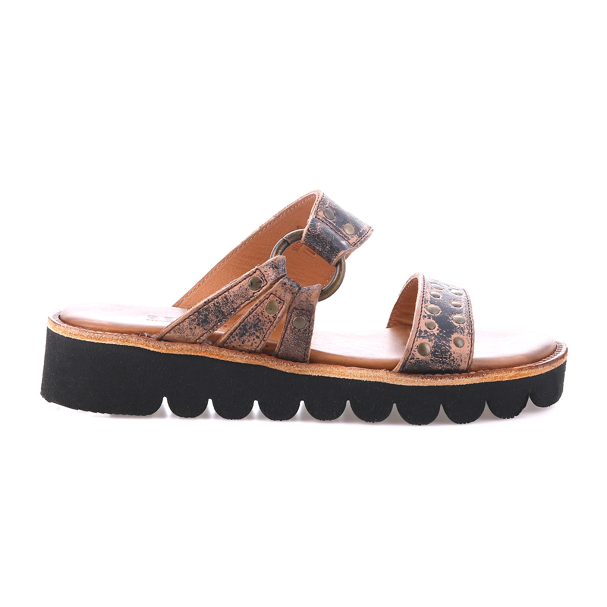 The Bed Stu Chow sandal features distressed brown leather, decorative metal accents, a cushioned tan footbed, and a chunky black platform sole with a wavy pattern.