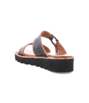 The Bed Stu Chow sandal showcases distressed leather crisscross straps and a chunky rubber sole on a white background.