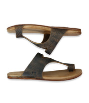 A pair of brown slip-on Civilized sandals by Bed Stu with a single wide strap and toe separator, crafted from exceptional quality materials, featuring a cushioned sole for added comfort, laying side by side on a white background.