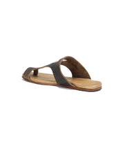 A single brown leather slide sandal, the Civilized by Bed Stu, with an open toe and cut-out design, crafted from vegetable-tanned leather and viewed from the back angle on a white background.