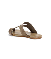 A single brown slip-on sandal made from exceptional quality materials, featuring a cushioned sole and crossed straps, lies on its side against a white background. The product is named Civilized and is by the brand Bed Stu.