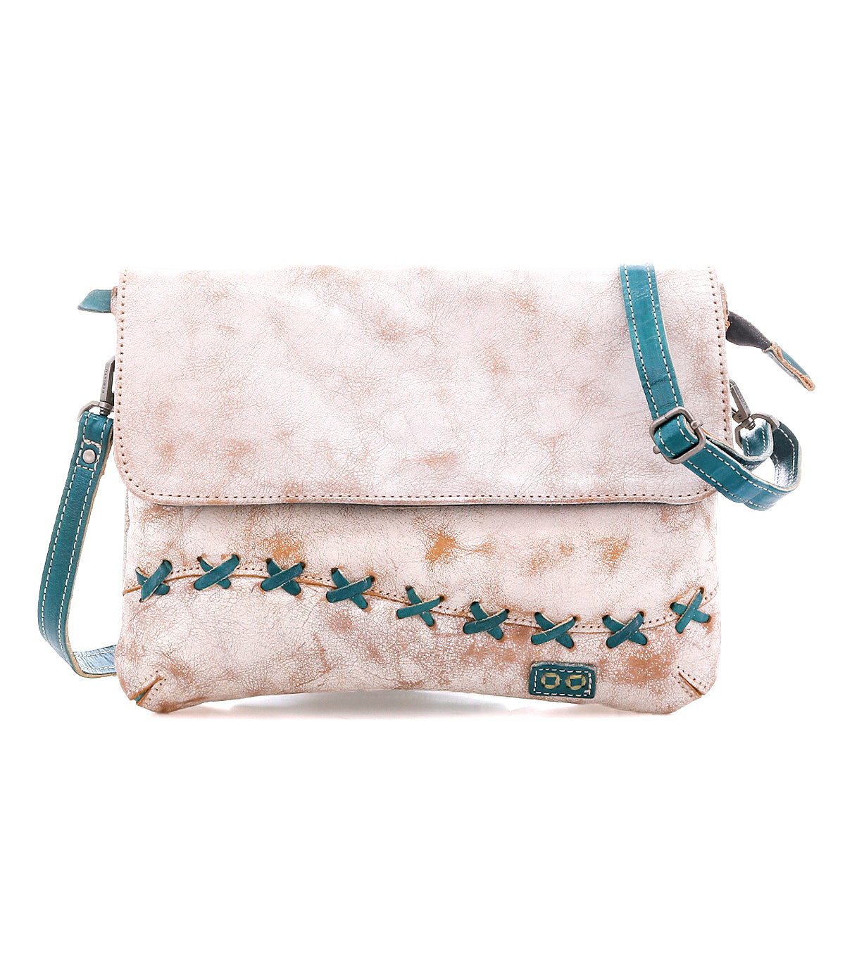 The Cleo crossbody bag by Bed Stu features light brown faux leather, a flap closure, an adjustable teal strap, and bold teal X-shaped stitching on the front.