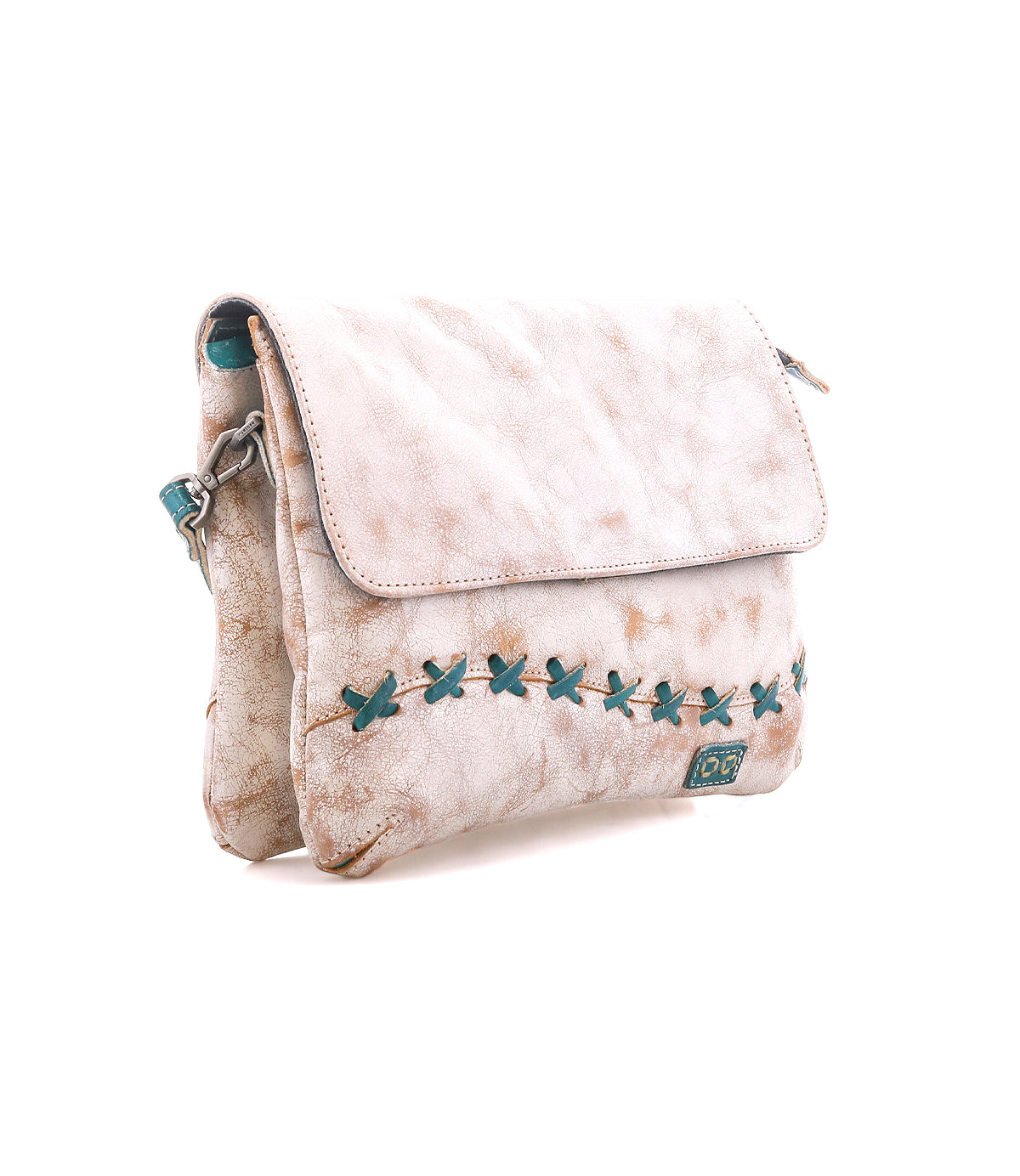 The Cleo by Bed Stu is a light beige leather crossbody bag with an adjustable strap, flap closure, teal X-shaped stitching, and a small front logo patch.