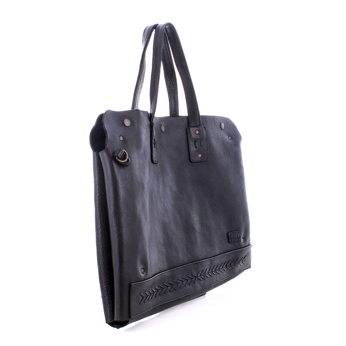 The Bed Stu Commuter is a black leather tote bag with dual handles, metal rivets, and decorative bottom stitching. This stylish accessory offers laptop storage and is pictured against a white background.
