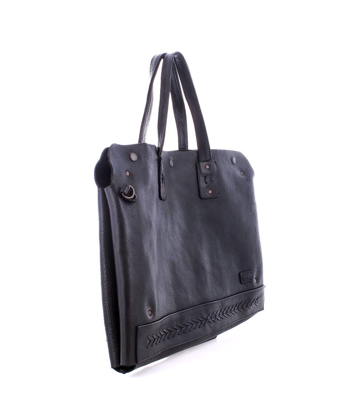 The Bed Stu Commuter is a black leather tote bag with dual handles, metal rivets, and decorative bottom stitching. This stylish accessory offers laptop storage and is pictured against a white background.