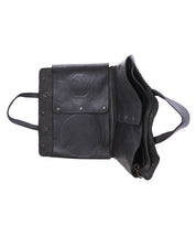 The Bed Stu Commuter is a black leather satchel with a flap, interior compartments, and side handle—this multifunctional bag provides convenient laptop storage for everyday use.