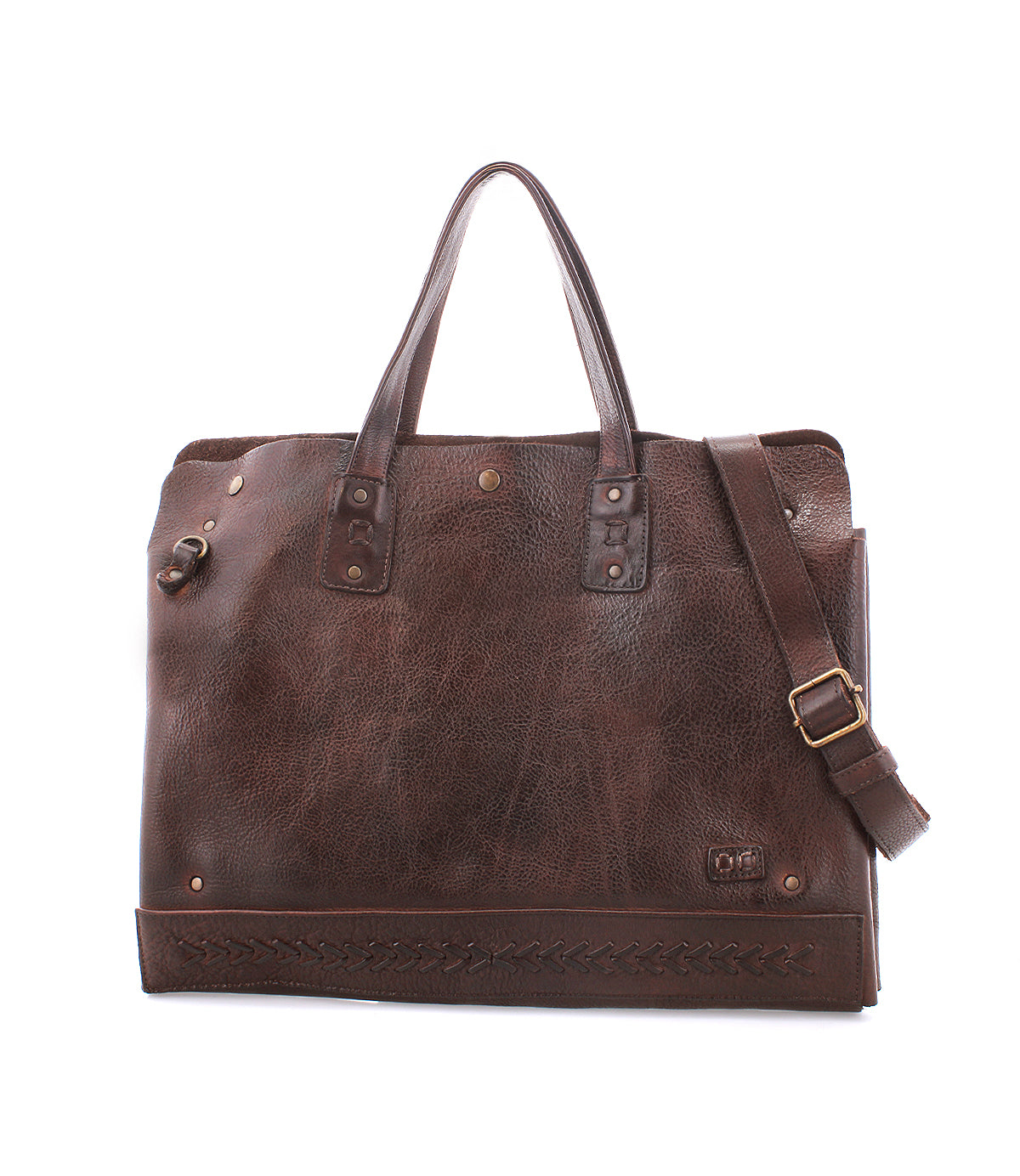 The Bed Stu Commuter is a brown leather tote featuring two handles, a detachable shoulder strap, metal rivets, decorative bottom stitching, and roomy laptop storage—the perfect multifunctional bag for everyday use.