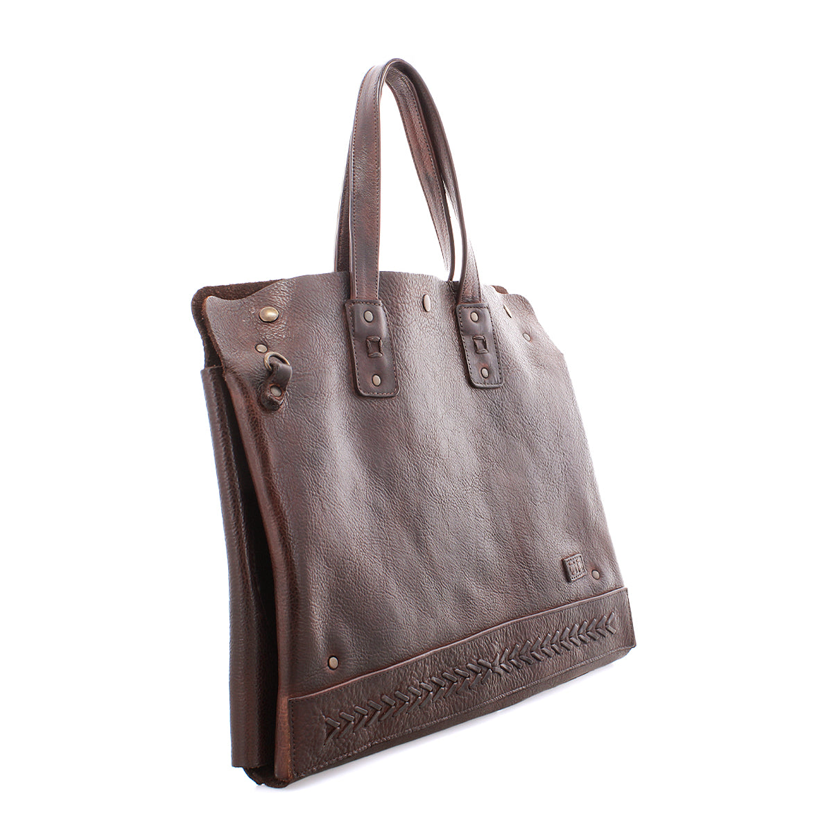 The Bed Stu Commuter is a brown leather tote bag with double handles, decorative stitching by the base, and metal rivet accents. Ideal as a multifunctional commuter bag, it's shown here against a white background.