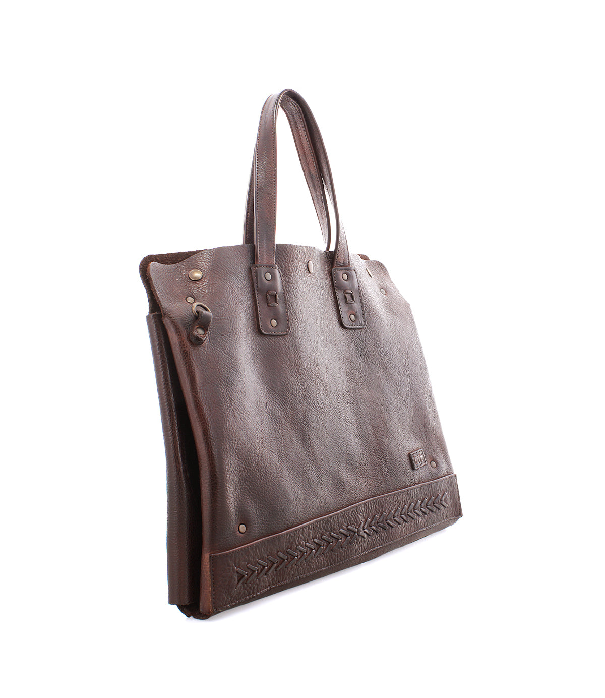The Bed Stu Commuter is a brown leather tote bag with double handles, decorative stitching by the base, and metal rivet accents. Ideal as a multifunctional commuter bag, it's shown here against a white background.