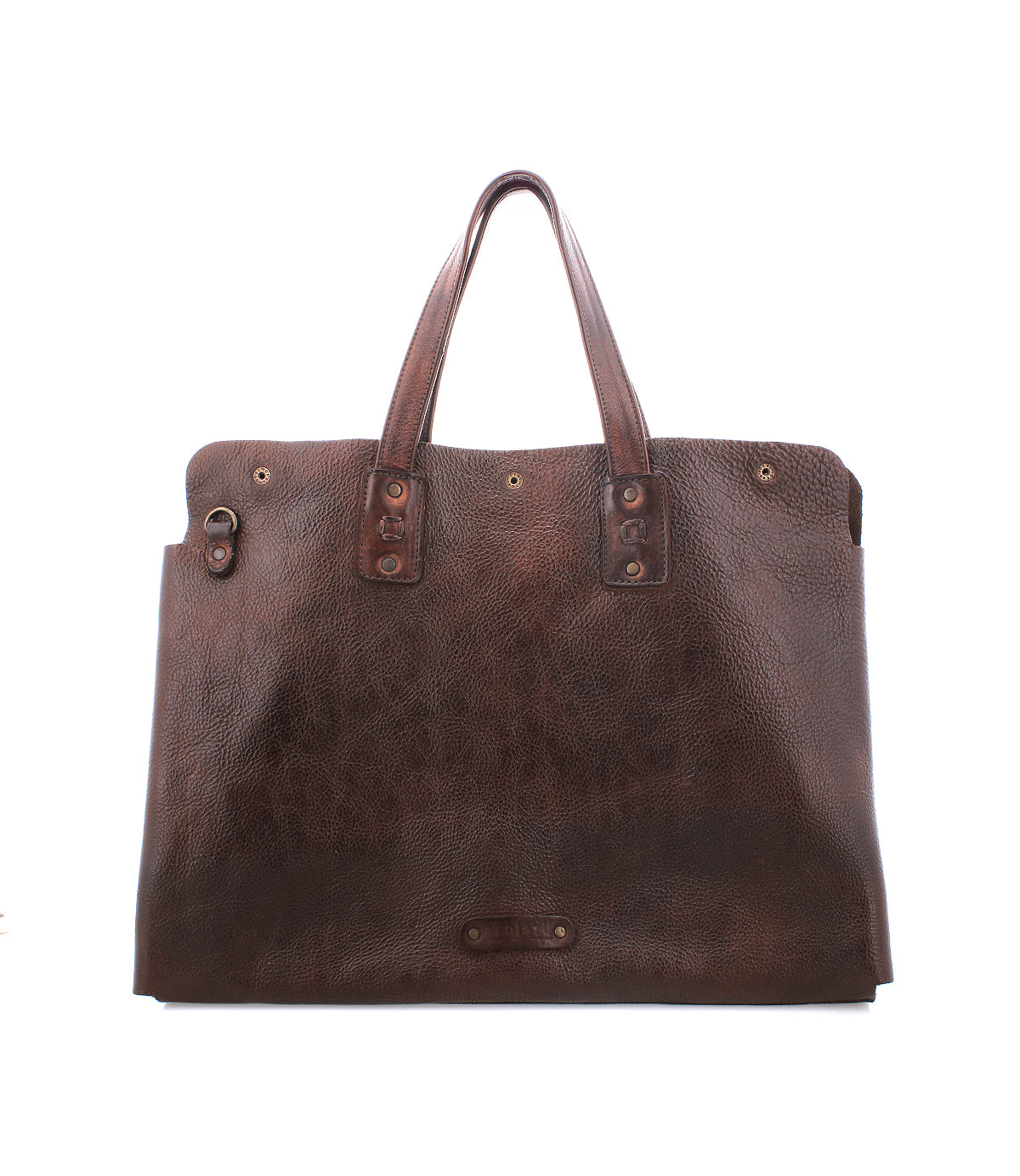 The Bed Stu Commuter is a large brown leather tote with two handles and metal rivet accents, featuring spacious laptop storage, shown on a white background.